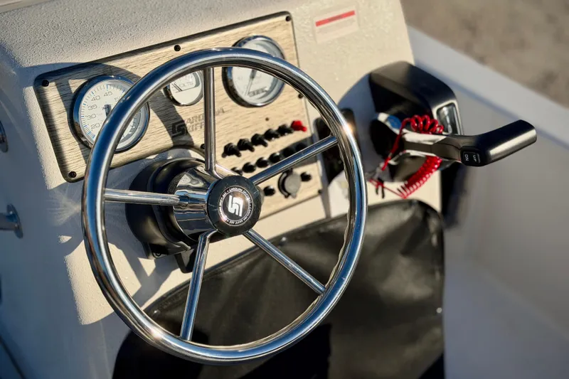 Slide: The Image of Steering wheel and controls of 2026 Carolina Skiff E18 JVX CC boat. - 10