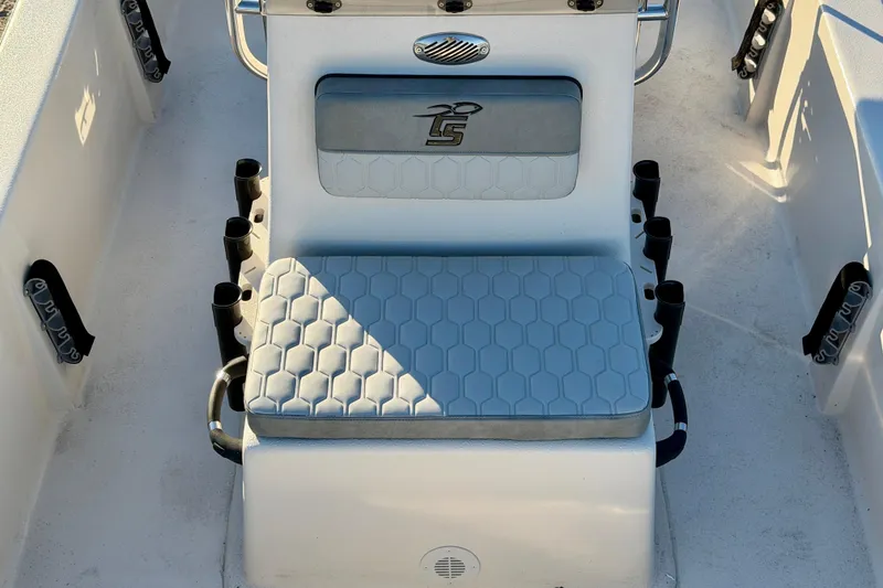 Slide: The Image of 2026 Carolina Skiff E18 JVX CC boat interior with cushioned seating and rod holders. - 14