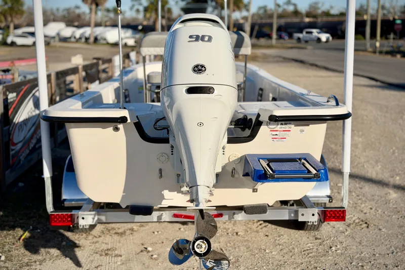 Slide: The Image of 2026 Carolina Skiff E18 JVX CC boat with 90 HP outboard motor, rear view. - 4