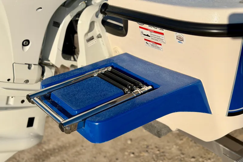 Slide: The Image of 2026 Carolina Skiff E18 JVX CC boat ladder detail in blue and white. - 5
