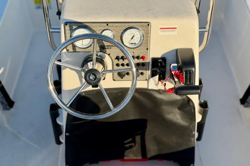Slide: The Image of Steering console of 2026 Carolina Skiff E18 JVX CC boat with gauges and controls. - 7