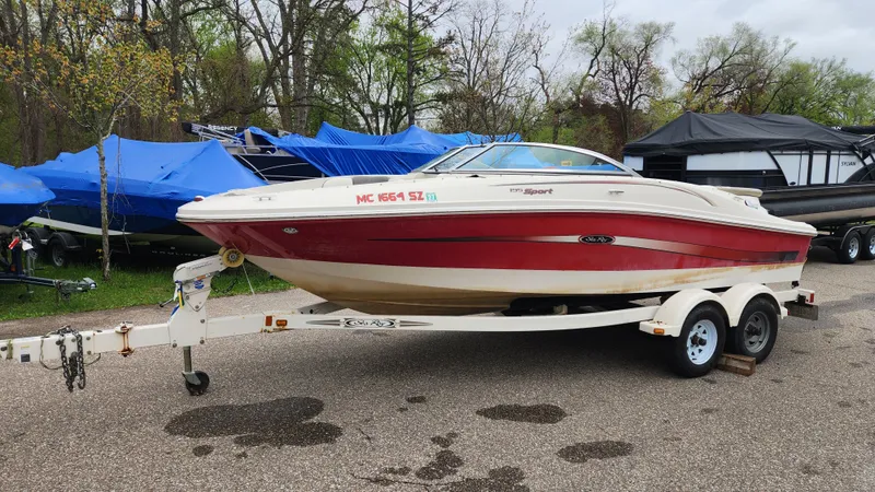 The Image of 2006 Sea Ray 195 Sport boat on trailer parked outdoors. - 0