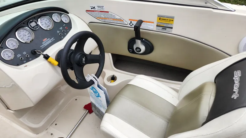 Slide: The Image of Interior of a 2006 Sea Ray 195 Sport boat with steering wheel and dashboard. - 11