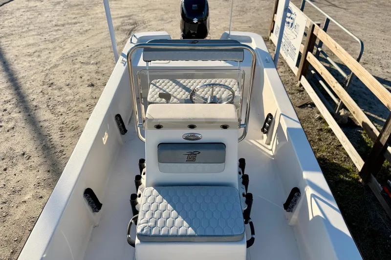 Slide: The Image of 2026 Carolina Skiff E18 JVX CC boat interior with seating and steering wheel. - 11