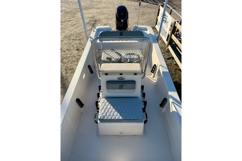 Slide: The Image of 2026 Carolina Skiff E18 JVX CC boat interior with seating and steering console. - 12
