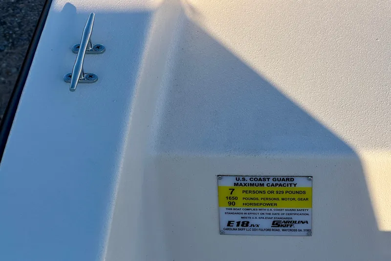 Slide: The Image of 2026 Carolina Skiff E18 JVX CC boat capacity label, showing U.S. Coast Guard specifications. - 16