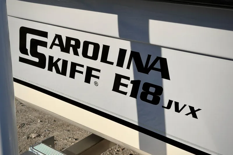 Slide: The Image of Carolina Skiff E18 JVX CC 2026 model logo on boat exterior. - 2