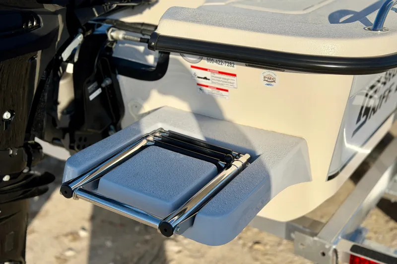 Slide: The Image of 2026 Carolina Skiff E18 JVX CC boat with a foldable swim ladder. - 6