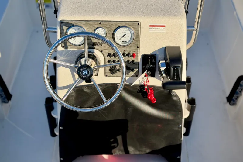 Slide: The Image of Steering console of 2026 Carolina Skiff E18 JVX CC boat with gauges and controls. - 7