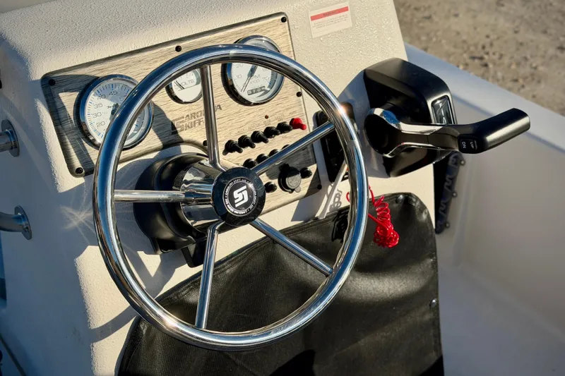 Slide: The Image of Steering console of 2026 Carolina Skiff E18 JVX CC boat with gauges and controls. - 8