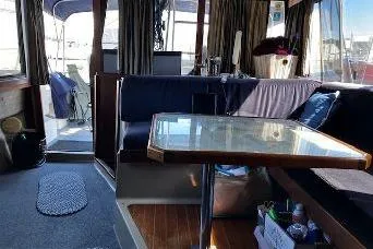 Slide: The Image of Interior of 1985 Bayliner 3270 Motoryacht with dining area and seating. - 11