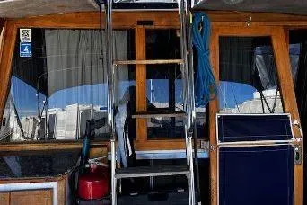 Slide: The Image of 1985 Bayliner 3270 Motoryacht cockpit with ladder and nautical equipment. - 4