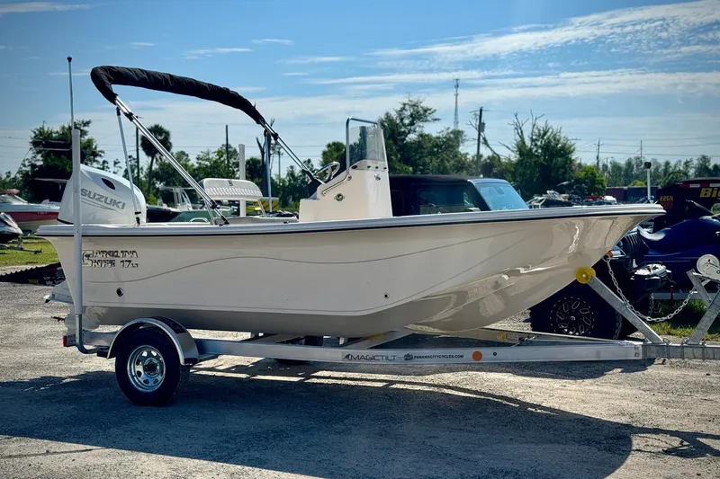 The Image of 2025 Carolina Skiff 17 LS boat on trailer, featuring Suzuki outboard motor. - 0