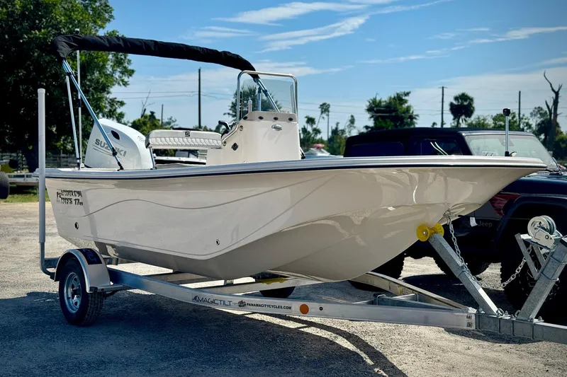 Slide: The Image of 2025 Carolina Skiff 17 LS boat on trailer, parked outdoors. - 12