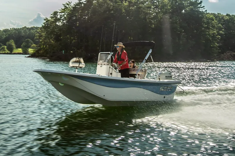 Slide: The Image of Manufacturer Provided Image: 2025 Carolina Skiff 17 LS boat cruising on a scenic lake. - 14