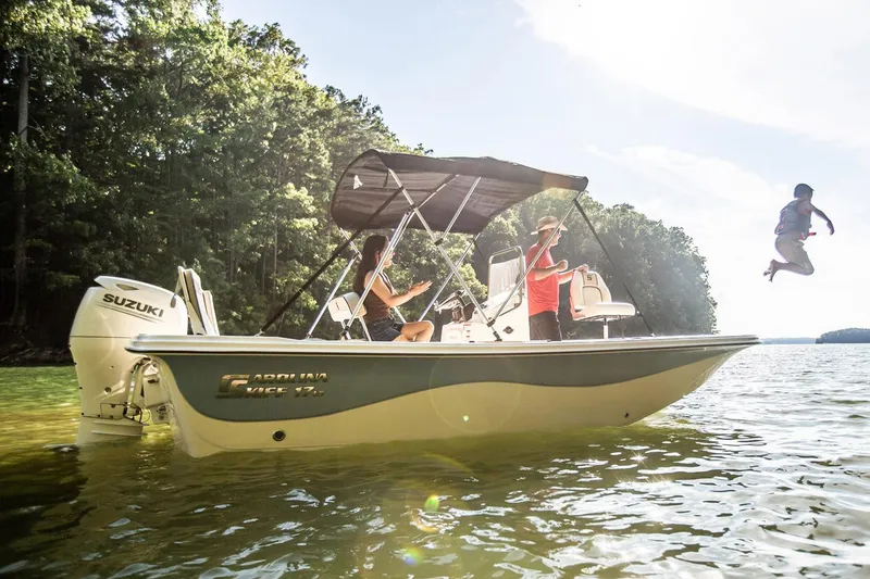 Slide: The Image of Manufacturer Provided Image: 2025 Carolina Skiff 17 LS boat on water, people enjoying, child jumping, sunny day. - 17