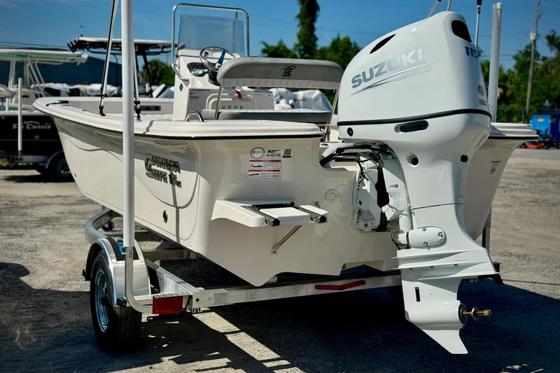 Slide: The Image of 2025 Carolina Skiff 17 LS boat with Suzuki outboard motor on trailer. - 2