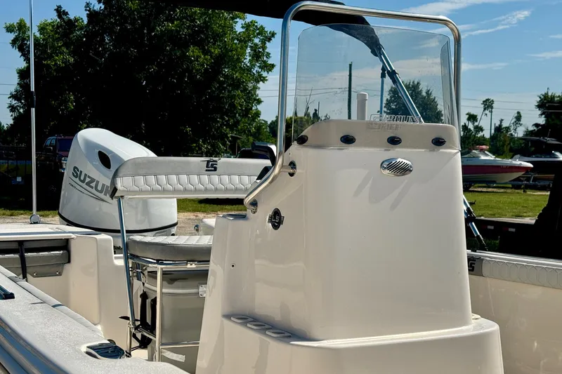 Slide: The Image of 2025 Carolina Skiff 17 LS boat with Suzuki outboard motor, parked outdoors. - 6