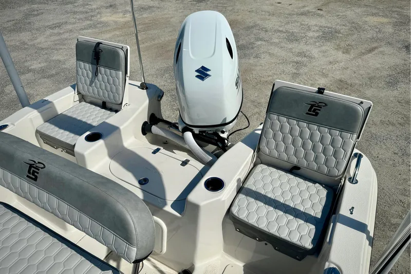 Slide: The Image of 2025 Carolina Skiff 17 LS boat interior with seating and Suzuki outboard motor. - 8