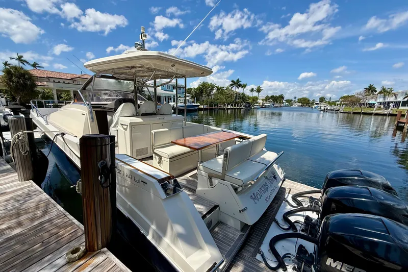 Slide: The Image of 2014 Azimut Verve 40 yacht docked by a scenic waterfront under a blue sky. - 12