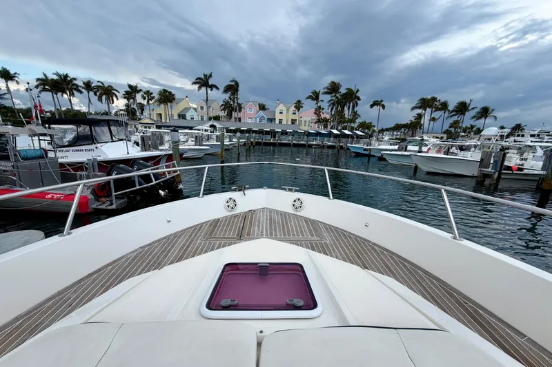 Slide: The Image of Azimut Verve 40 yacht docked at marina with palm trees and colorful buildings, 2014 model. - 14