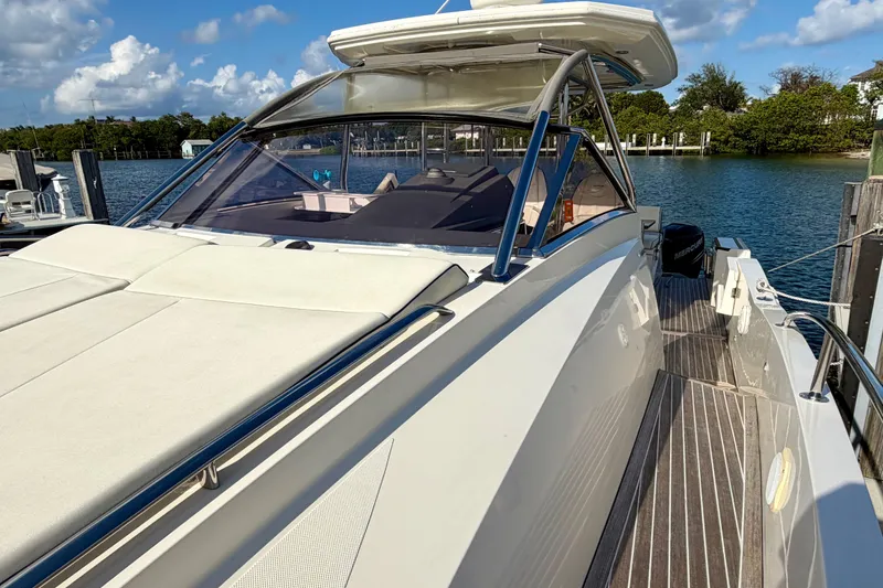 Slide: The Image of 2014 Azimut Verve 40 yacht docked by serene waters under a blue sky. - 19