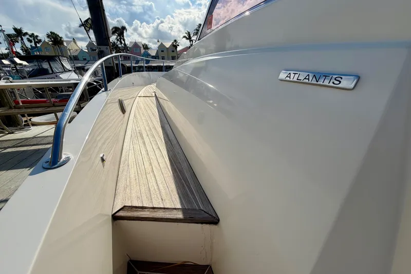 Slide: The Image of 2014 Azimut Verve 40 yacht deck with Atlantis branding, docked under a sunny sky. - 23