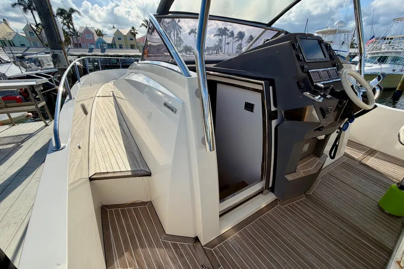 Slide: The Image of 2014 Azimut Verve 40 yacht cockpit with helm and wooden deck. - 25