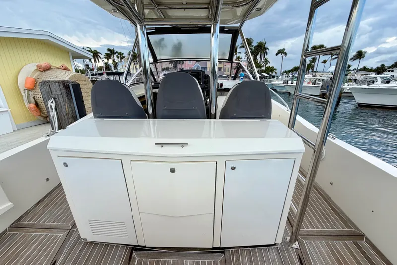 Slide: The Image of 2014 Azimut Verve 40 yacht interior with helm seats and cabinetry, docked at marina. - 33