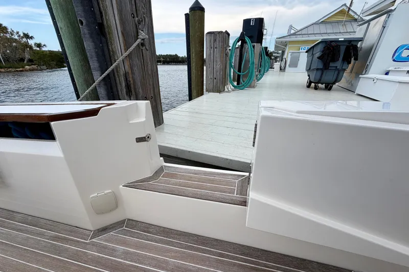 Slide: The Image of Azimut Verve 40 yacht docked at marina, showcasing sleek design and wooden deck. - 41