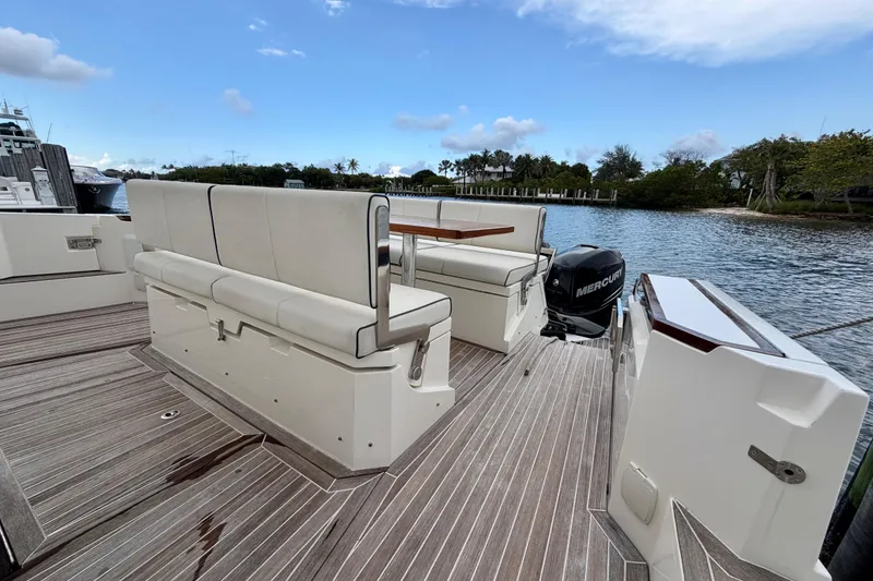 Slide: The Image of Azimut Verve 40 yacht deck with seating, 2014 model, docked by a scenic waterway. - 43