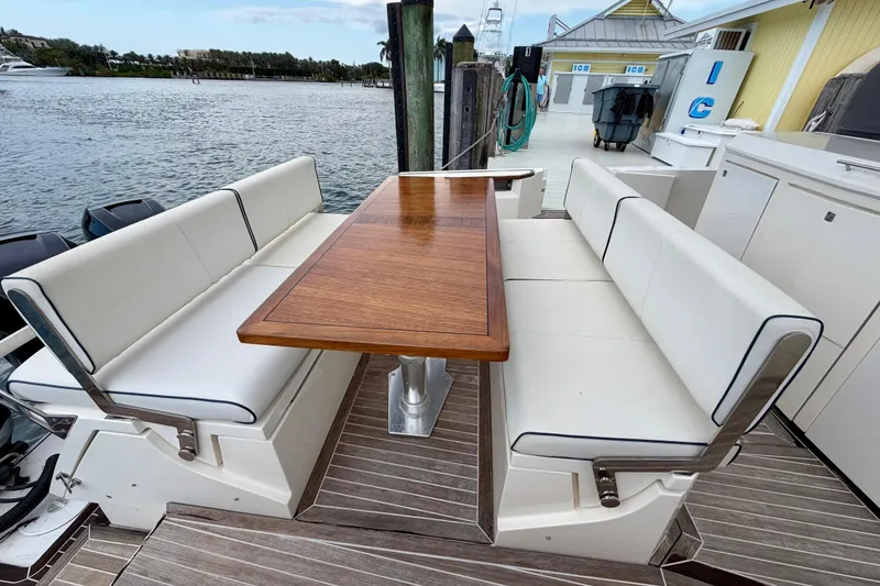 Slide: The Image of Luxury seating area on 2014 Azimut Verve 40 yacht, featuring elegant wooden table. - 44