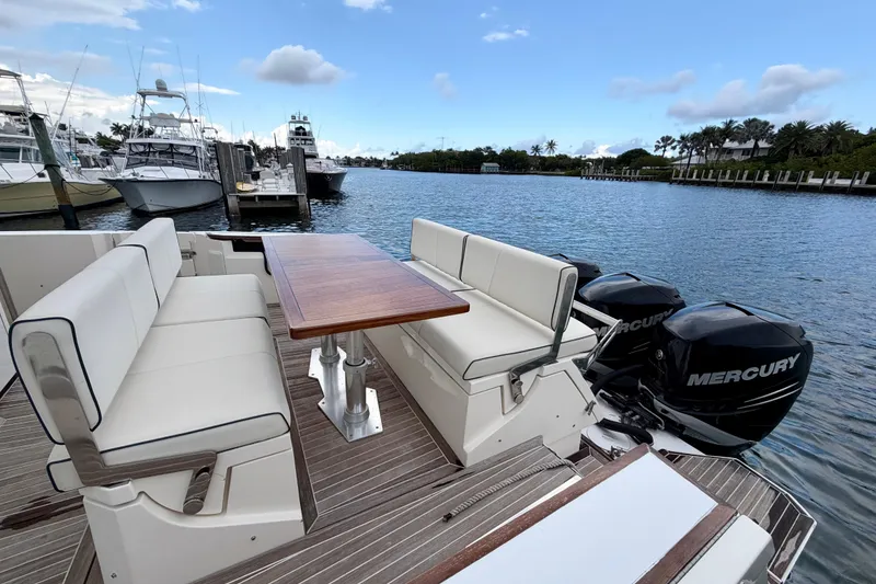 Slide: The Image of Azimut Verve 40 yacht, 2014 model, with seating and table, docked by the water. - 45