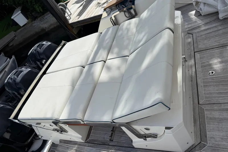 Slide: The Image of Azimut Verve 40 boat seating area, 2014 model, with white cushioned seats and outboard motors. - 47