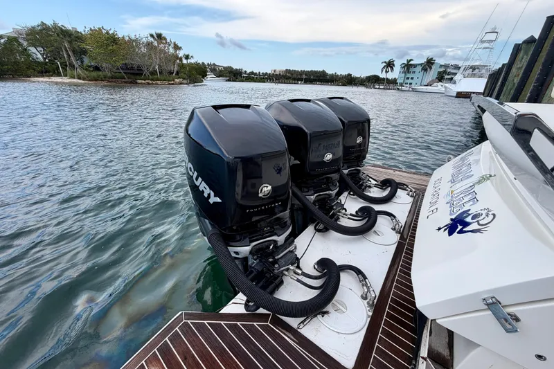 Slide: The Image of Azimut Verve 40 boat with triple Mercury outboard engines, docked by scenic waterfront. - 48