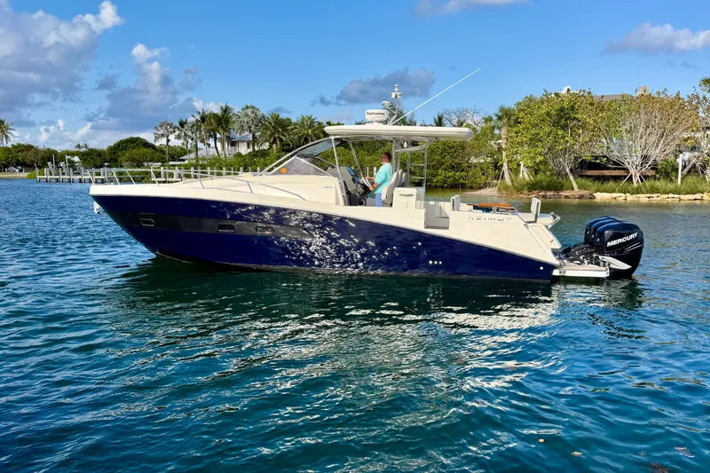 Slide: The Image of 2014 Azimut Verve 40 yacht cruising on a sunny day near lush shoreline. - 5