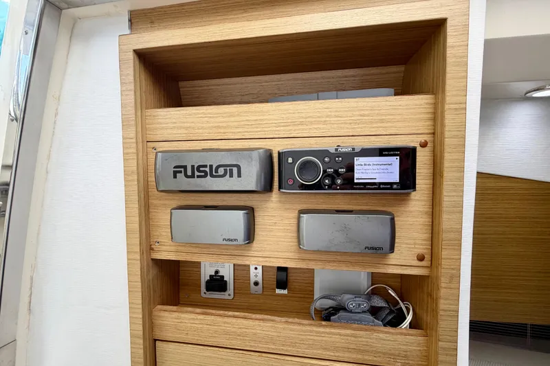 Slide: The Image of Fusion stereo system on 2014 Azimut Verve 40 yacht, featuring wooden paneling. - 50