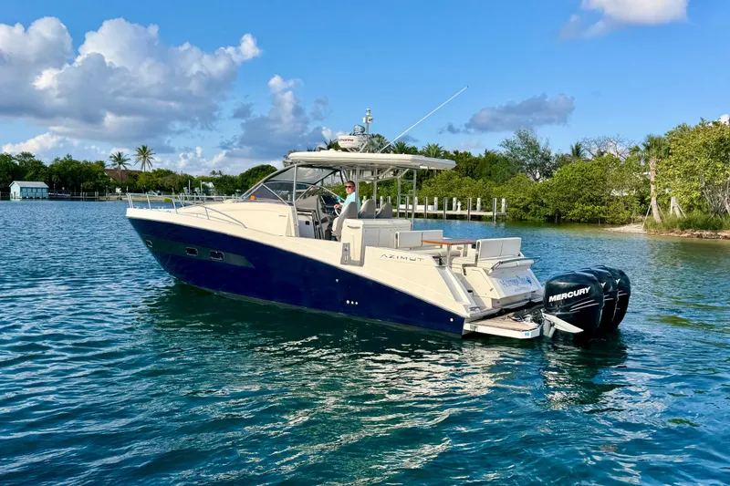 Slide: The Image of Azimut Verve 40 yacht from 2014 on calm water, featuring Mercury outboard engines. - 7