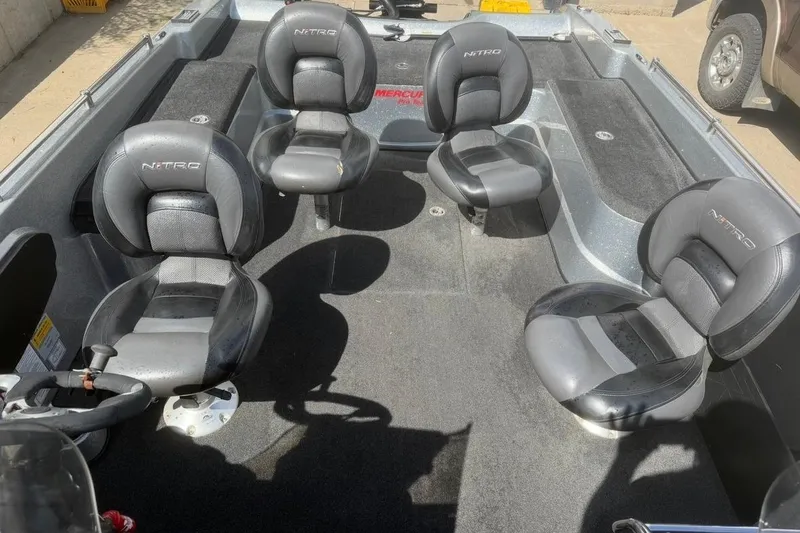 Slide: The Image of Interior of a 2015 Nitro ZV21 boat with four black seats. - 10