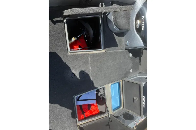 Slide: The Image of 2015 Nitro ZV21 boat storage compartments with safety equipment and accessories. - 11