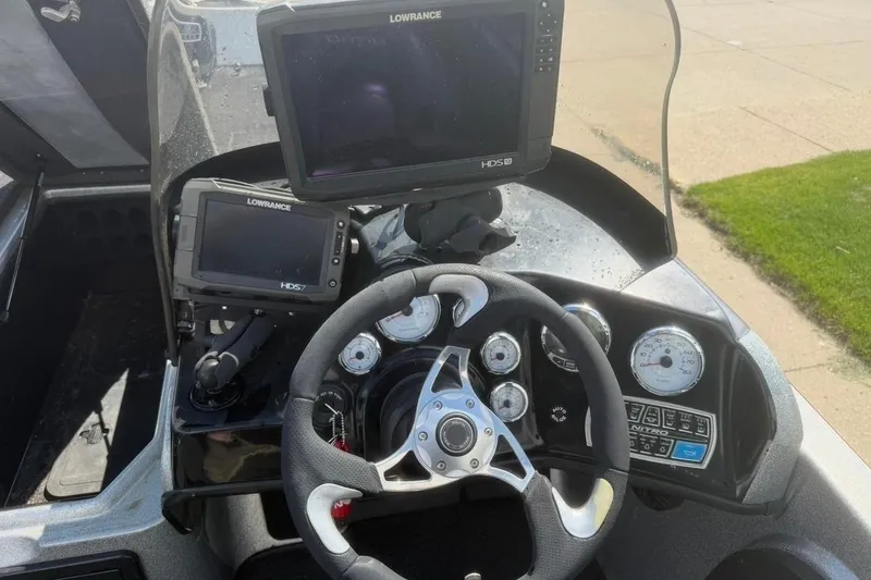 Slide: The Image of 2015 Nitro ZV21 boat dashboard with Lowrance HDS displays and steering wheel. - 13