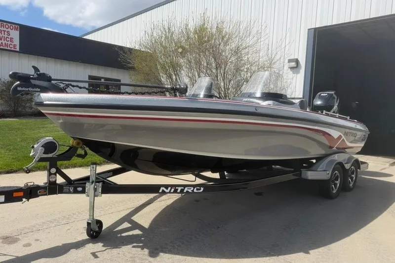 Slide: The Image of 2015 Nitro ZV21 boat on trailer, parked outside a building. - 2