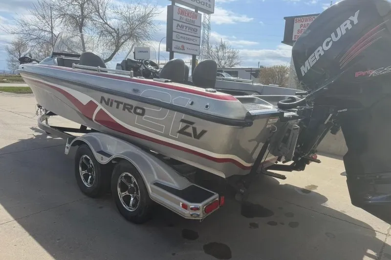Slide: The Image of 2015 Nitro ZV21 boat with Mercury engine on trailer in outdoor setting. - 3