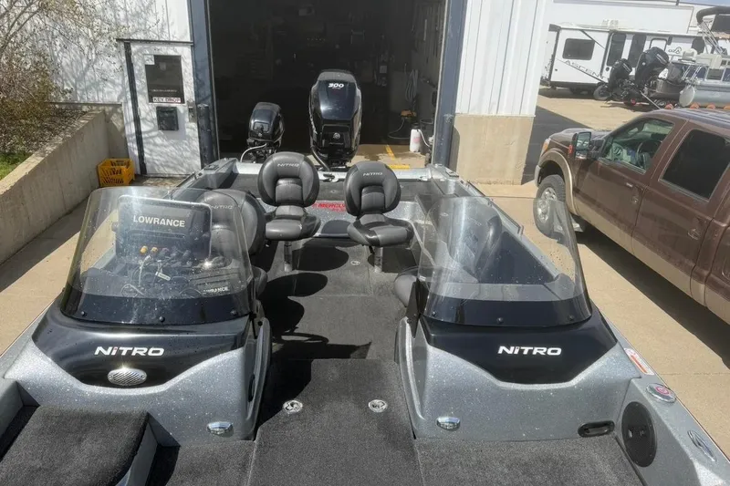 Slide: The Image of 2015 Nitro ZV21 boat with dual consoles and Lowrance electronics, parked near a garage. - 9