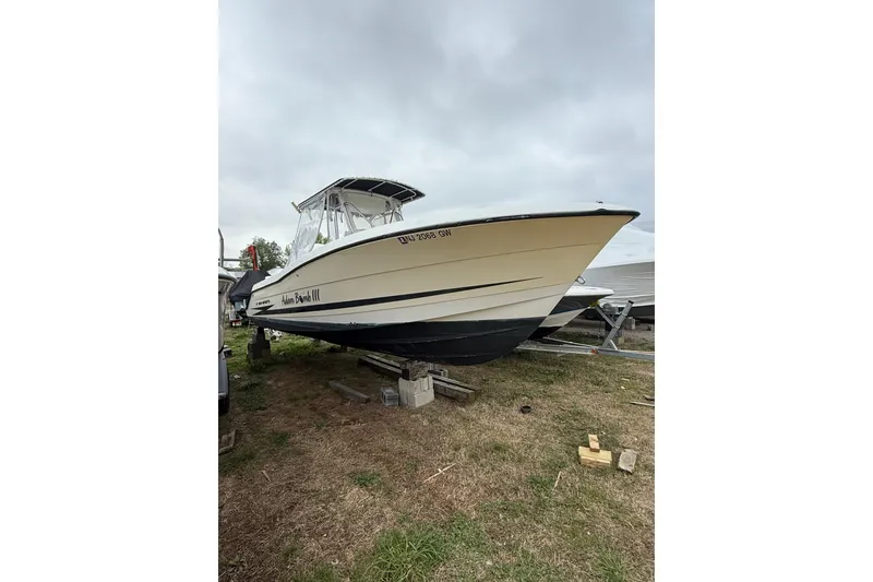 Slide: The Image of 2003 Hydra-Sports Vector 2800 CC boat on land, overcast sky. - 11