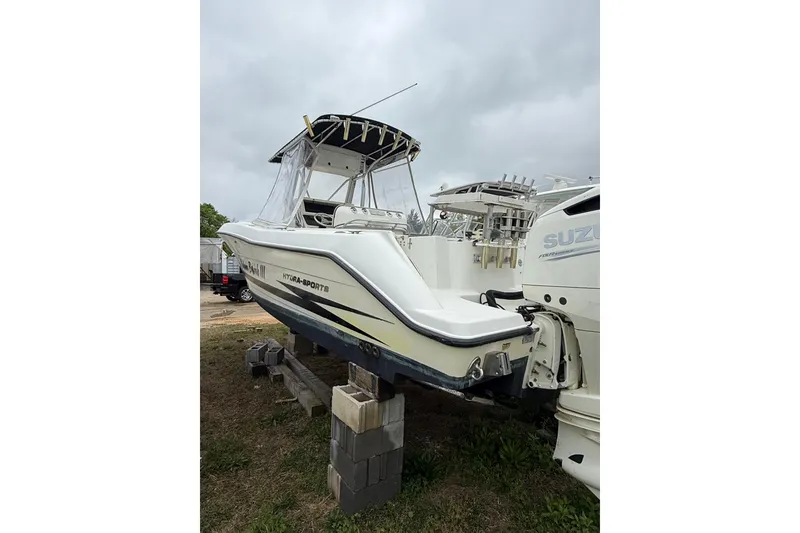 Slide: The Image of 2003 Hydra-Sports Vector 2800 CC boat on blocks, overcast sky background. - 13