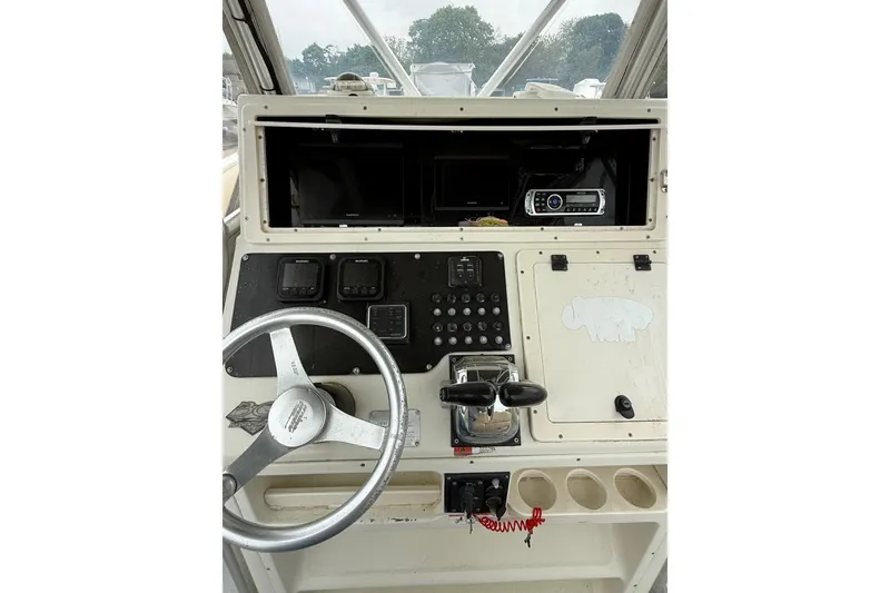 Slide: The Image of Console of 2003 Hydra-Sports Vector 2800 CC boat with steering wheel and controls. - 16