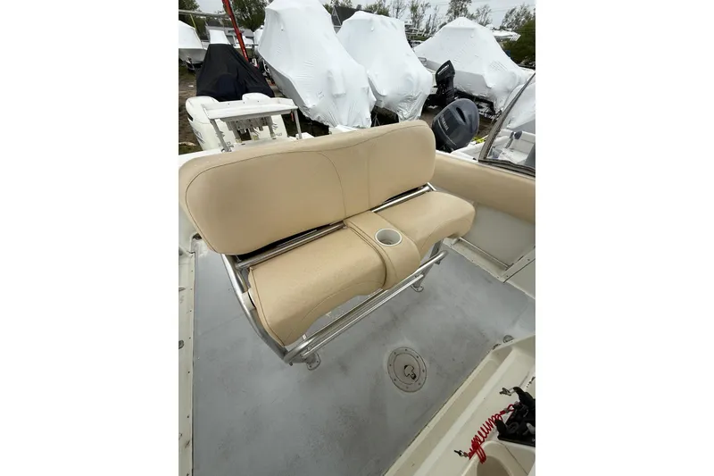 Slide: The Image of 2003 Hydra-Sports Vector 2800 CC boat interior with beige seating and cup holder. - 17