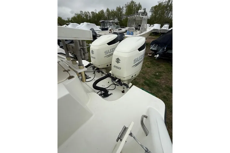 Slide: The Image of 2003 Hydra-Sports Vector 2800 CC with twin Suzuki outboard motors, parked outdoors. - 20
