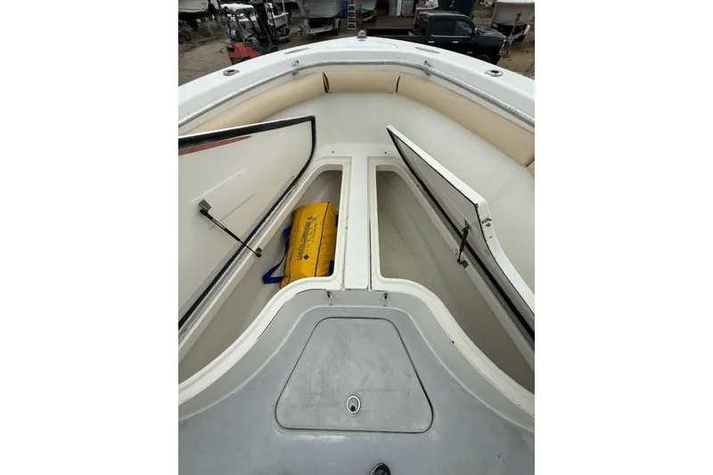 Slide: The Image of 2003 Hydra-Sports Vector 2800 CC boat storage compartments with open hatches and visible gear. - 28